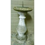 A sundial, the circular top with brass dial and gnomon on a concrete baluster pillar