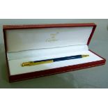 A Must de Cartier ball point pen in blue lacquered and gilt metal pen, in original case