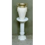 A two handled urn of classical design and associated fluted column