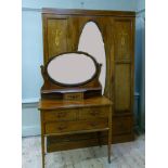 An Edwardian mirror door wardrobe with two drawers below on plinth base, together with an associated