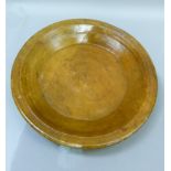 A large turned wood bowl, later varnished, 45.5cm diameter