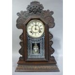 An Ansonia mantel clock with carved floral decoration, 58cm high