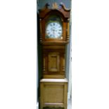 A Victorian fruitwood longcase clock having an arched dial painted with a maiden and dog to the arch
