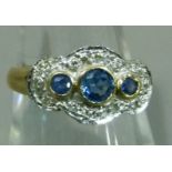 A sapphire and diamond cluster ring in 9ct gold the graduated circular faceted sapphires collet