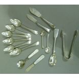 Two silver butter knives, three condiment spoons, a mother of pearl handled butter knife and