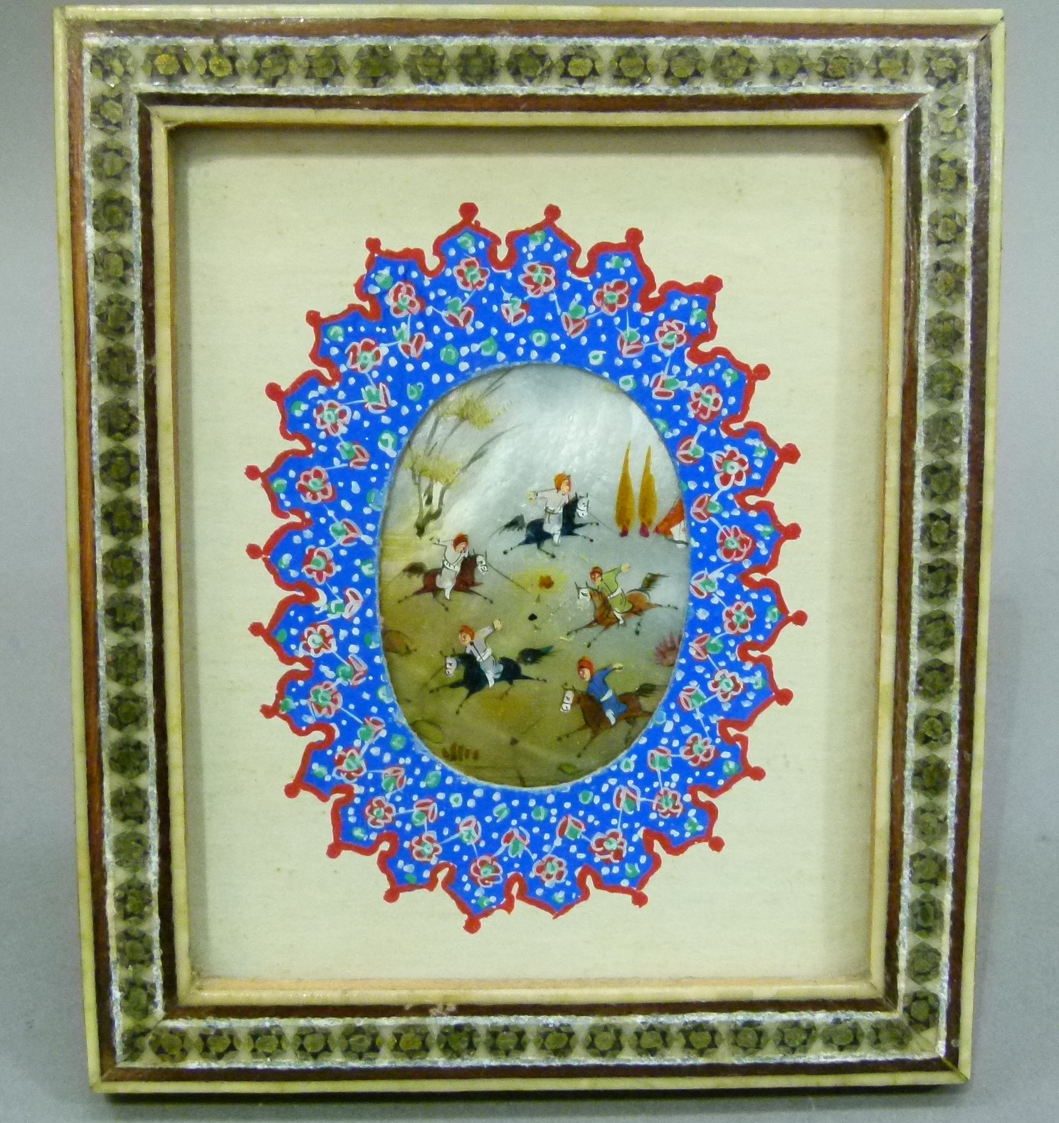 A Persian miniature, the oval shell painted with figures on horseback within a landscape, within a - Image 2 of 2