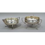 A silver sugar and cream, circular shallow bowl to each on three pad feet, the sugar bowl with three