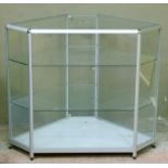 A display cabinet of canted rectangular outline, 93cm high x 107cm wide