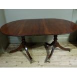 A Regency style mahogany dining table with D-shaped ends and additional leaf supported on turned