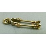 A 9ct coal tongs charm by Alabaster & Wilson