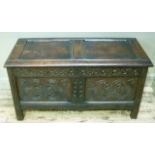 An early 18th century and later jointed chest, having a twin indented panel top above a carved