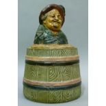 A 19th century Austrian pottery tobacco jar and cover modelled as a jovial gentleman wearing a broad