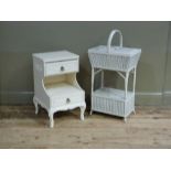 A white painted wicker two tier work basket, together with a cream bedside cabinet
