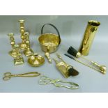 An 18pdr brass shell case, brass candlesticks, a brass jam pan, fire tools etc