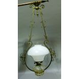 A hanging oil lantern with gilt metal frame, white shade and marbled glass reservoir