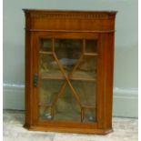 A small mahogany hanging corner cupboard with glass tracery glazed single door, 60cm high x 47cm