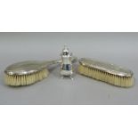 A silver backed hair brush and clothes brush, Birmingham 1926 and a pepperette, Birmingham 1960