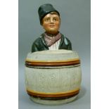 An 19th century Austrian pottery tobacco jar and cover modelled as a young countryman in traditional