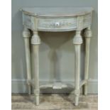 A cream finish console table of bowed outline having a drawer with applied foliate spray, flanked by