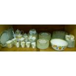 A large quantity of Portuguese porcelain dinner and breakfast ware transfer printed with oranges and