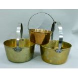 Three brass preserve pans with steel hoop handles, various sizes