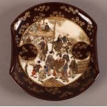 A JAPANESE POTTERY DISH, MEIJI PERIOD, of folded circular outline, painted with figures in a garden,