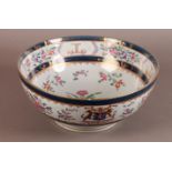 A SAMSON PARIS FAMILLE ROSE STYLE PUNCH BOWL decorated with an armorial and motto 'Fortis in Bello',