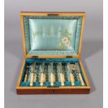 A SET OF SIX SILVER PLATED FISH KNIVES AND FORKS with foliate trail engraved blades and finely