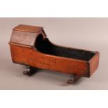 A MAHOGANY DOLL'S CRADLE, 39cm long x 15.5cm wide