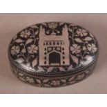 A PERSIAN SILVER INLAID IRON BOX AND COVER, oval, the top with mosque within a floral frame, the
