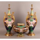 A ROYAL CROWN DERBY GARNITURE of a pair of two-handled lamps and a vase of baluster outline,