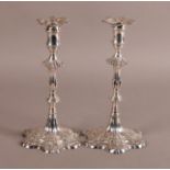 A CLOSELY MATCHED PAIR OF GEORGE III CAST SILVER CANDLESTICKS, London 1763 by Thomas Hannam &
