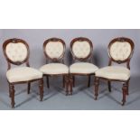 A SET OF FOUR VICTORIAN MAHOGANY DINING CHAIRS each having a buttoned upholstered oval back with