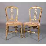 A PAIR OF VICTORIAN GILTWOOD BEDROOM CHAIRS the open backs foliate carved to the centre top above