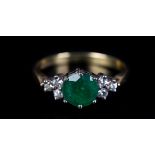 AN EMERALD AND DIAMOND RING in 18ct yellow and white gold, claw set to the centre with a circular
