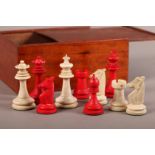 A STAINED IVORY CHESS SET of Staunton pattern, in mahogany box, early 20th century