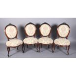 A SET OF FOUR VICTORIAN ROSEWOOD DINING CHAIRS, having an oval back, the encircling frame with