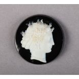 A 19TH CENTURY ONYX CAMEO the circular profile female portrait with dressed hair and jewellery,