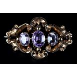 A VICTORIAN AMETHYST SET BROOCH in 9ct gold the three oval faceted graduated stones collet set