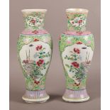 A PAIR OF 19TH CENTURY CHINESE FAMILLE VERTE VASES, the baluster bodies enamelled with rocks issuing