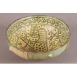 A NISHPUR 12TH CENTURY YELLOW AND GREEN POTTERY DEEP BOWL with a cat design and scrolling