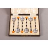 A SET OF SIX ART DECO 'BELISHA BEACON' SILVER AND ENAMEL COFFEE TEASPOONS with orange ceramic