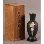 A JAPANESE CLOISONNE ENAMEL BALUSTER VASE with opaque black ground decorated in yellow, blue and