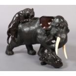 A FINE JAPANESE BRONZE SCULPTURE OF A MALE ELEPHANT being attacked by two tigers, one upon its back,