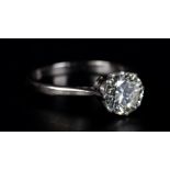 A SINGLE STONE DIAMOND RING in platinum the brilliant cut stone claw set flanked by tubed shoulders,