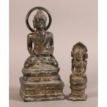 A CAST BRONZE FIGURE OF A SEATED BUDDHA with leaf behind, 12.5cm high, filled; together with another