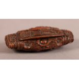 A FINE 19TH CENTURY COQUILLA NUT SNUFF BOX, the hinged lid pierced and finely carved with stylised