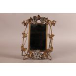 AN ART NOUVEAU BRASS AND WHITE METAL SMALL DRESSING TABLE MIRROR, the bevelled plate within a