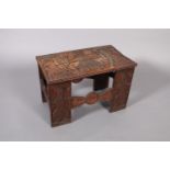 AN INTERESTING AFRICAN STOOL OR TABLE, the rectangular top relief carved with a central figure