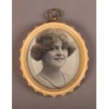 AN OVAL IVORY FRAME WITH FLUTED BORDER, moulded and concave turned slip, bevelled glass and brass